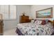 Neutral-toned bedroom featuring floral bedding, shutters, and framed print above the bed at 13566 N 93Rd Pl, Scottsdale, AZ 85260