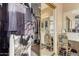 A large walk-in closet featuring custom shelving and storage and adjoined to the bathroom at 13566 N 93Rd Pl, Scottsdale, AZ 85260