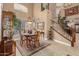 Dining room featuring a grand staircase, with natural light and stylish decor at 13566 N 93Rd Pl, Scottsdale, AZ 85260