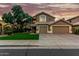 Charming two-story home featuring a well-manicured lawn and an attached three-car garage at 13566 N 93Rd Pl, Scottsdale, AZ 85260