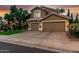 Charming two-story home featuring a well-manicured lawn and an attached three-car garage at 13566 N 93Rd Pl, Scottsdale, AZ 85260