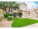 Charming two-story home featuring a well-manicured lawn and an attached three-car garage at 13566 N 93Rd Pl, Scottsdale, AZ 85260