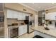 Spacious kitchen with white cabinetry, granite countertops, stainless appliances, and wine cooler at 13566 N 93Rd Pl, Scottsdale, AZ 85260