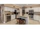 Well-lit kitchen with white cabinets, granite countertops, and stainless steel appliances at 13566 N 93Rd Pl, Scottsdale, AZ 85260