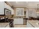 Kitchen featuring stainless steel appliances, granite counters, and ample cabinet space at 13566 N 93Rd Pl, Scottsdale, AZ 85260