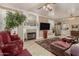 Bright living room with fireplace, media center, and open floor plan at 13566 N 93Rd Pl, Scottsdale, AZ 85260