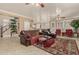 Open-concept living room with fireplace, kitchen access, and natural light at 13566 N 93Rd Pl, Scottsdale, AZ 85260