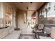 Covered patio features comfortable seating, a view of the backyard, and access to both the indoors and outdoors at 13566 N 93Rd Pl, Scottsdale, AZ 85260