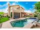 Tranquil backyard featuring a pool and spa combo, lush landscaping, and outdoor seating at 13566 N 93Rd Pl, Scottsdale, AZ 85260