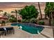 Backyard pool and spa with green lawn, patio, and lush landscaping creating a private and inviting outdoor space at 13566 N 93Rd Pl, Scottsdale, AZ 85260