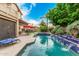 Beautiful pool area with covered patio, seating, and spa surrounded by lush landscaping at 13566 N 93Rd Pl, Scottsdale, AZ 85260