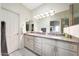 Bathroom features a dual sink vanity, ample lighting, and modern fixtures at 13584 N 102Nd Pl, Scottsdale, AZ 85260