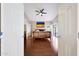Bedroom with wood floors, ceiling fan, and access to the backyard through sliding glass doors at 13584 N 102Nd Pl, Scottsdale, AZ 85260