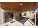 Relaxing covered patio area with tile flooring, wood ceiling, outdoor seating, and desert landscaping at 13584 N 102Nd Pl, Scottsdale, AZ 85260