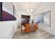 Bright dining room featuring a wood table, hutch, chandelier, and light wood floors at 13584 N 102Nd Pl, Scottsdale, AZ 85260