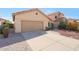 Beautiful front yard view featuring a two-car garage and a well-maintained concrete driveway at 13584 N 102Nd Pl, Scottsdale, AZ 85260