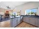 Bright kitchen featuring modern appliances, sleek countertops, and an open view to the living room at 13584 N 102Nd Pl, Scottsdale, AZ 85260