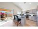 Bright kitchen with granite countertops, stainless steel appliances, and backyard patio access at 13584 N 102Nd Pl, Scottsdale, AZ 85260