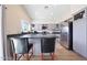 Charming kitchen area featuring granite countertops, stainless steel appliances, and barstool seating at 13584 N 102Nd Pl, Scottsdale, AZ 85260