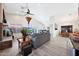Bright living room with vaulted ceilings, a fireplace, and a seamless transition to the dining area at 13584 N 102Nd Pl, Scottsdale, AZ 85260