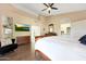 Primary bedroom boasts hardwood floors, ensuite bath, ceiling fan and open walk-in closet at 13584 N 102Nd Pl, Scottsdale, AZ 85260