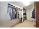 Spacious walk-in closet with extensive shelving and hanging storage for organized wardrobe at 13584 N 102Nd Pl, Scottsdale, AZ 85260