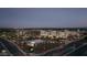 Scenic aerial view of a community featuring a mix of retail and residential buildings, landscaped walkways, and well-lit streets at dusk at 1492 S Pike Ln, Gilbert, AZ 85296