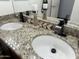 Close up of a double sink bathroom vanity featuring granite countertops, bronze faucets, and decorative accents at 1492 S Pike Ln, Gilbert, AZ 85296
