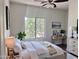 Bright bedroom features neutral colors, large window, ceiling fan, and a small desk at 1492 S Pike Ln, Gilbert, AZ 85296