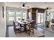 Elegant dining room with wood accent wall, large windows, stylish lighting, and seating for six at 1492 S Pike Ln, Gilbert, AZ 85296