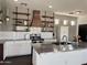 Kitchen featuring stainless steel island, white cabinets, subway tile backsplash, and open wood shelving at 1492 S Pike Ln, Gilbert, AZ 85296