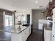 Open-concept kitchen featuring a large island, white cabinets, and direct access to dining and living areas at 1492 S Pike Ln, Gilbert, AZ 85296