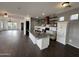 Bright, open kitchen featuring a stainless steel island, modern appliances, white cabinets, and wooden shelving at 1492 S Pike Ln, Gilbert, AZ 85296