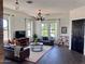 Cozy living room with dark hardwood floors, modern decor, and an abundance of natural light from large windows at 1492 S Pike Ln, Gilbert, AZ 85296
