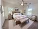 Serene main bedroom featuring a ceiling fan, neutral decor, and large windows offering plenty of natural light at 1492 S Pike Ln, Gilbert, AZ 85296
