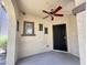 Covered patio featuring stucco walls, a ceiling fan, and a door with a security screen at 1492 S Pike Ln, Gilbert, AZ 85296