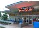 Joe's Farm Grill featuring a classic neon sign with blue accents and visible indoor seating through large glass windows at 1492 S Pike Ln, Gilbert, AZ 85296