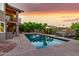 The backyard oasis features a pristine pool, spa, and lush landscaping, perfect for relaxation at 15237 S 19Th Way, Phoenix, AZ 85048