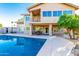 Gorgeous backyard with a refreshing pool, covered patio, and lush palm trees at 15237 S 19Th Way, Phoenix, AZ 85048