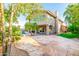 Beautifully landscaped backyard with a stone patio, palm trees, and lush greenery at 15237 S 19Th Way, Phoenix, AZ 85048
