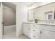 Bathroom featuring double sinks, white cabinets, and a shower-tub combo in neutral color palette at 15237 S 19Th Way, Phoenix, AZ 85048