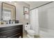 Cozy bathroom with vanity, toilet, tub, shower, framed art, and a modern black framed mirror at 15237 S 19Th Way, Phoenix, AZ 85048