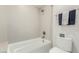 Bathroom featuring a bathtub-shower combo, updated tiling, and neutral color palette at 15237 S 19Th Way, Phoenix, AZ 85048