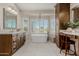 Elegant bathroom with a soaking tub, custom cabinets, and a lovely vanity area at 15237 S 19Th Way, Phoenix, AZ 85048