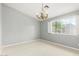 Bright bedroom features neutral walls, carpet, ornate chandelier and natural light from the window at 15237 S 19Th Way, Phoenix, AZ 85048