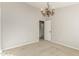 A vacant bedroom features neutral paint, carpet flooring, and a stylish chandelier at 15237 S 19Th Way, Phoenix, AZ 85048
