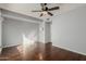 This bedroom includes hardwood flooring, a ceiling fan, and a wall lamp at 15237 S 19Th Way, Phoenix, AZ 85048