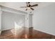 This bedroom has wood floors, ceiling fan, neutral paint, and an entry door for privacy at 15237 S 19Th Way, Phoenix, AZ 85048