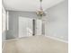 Bedroom featuring a chandelier, neutral color palette, a closet, and a bright window at 15237 S 19Th Way, Phoenix, AZ 85048