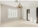 Bedroom featuring a chandelier, closet, and a bright window with wood shutters at 15237 S 19Th Way, Phoenix, AZ 85048